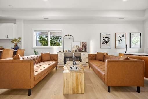 A living room with brown leather couches and a wooden coffee table.