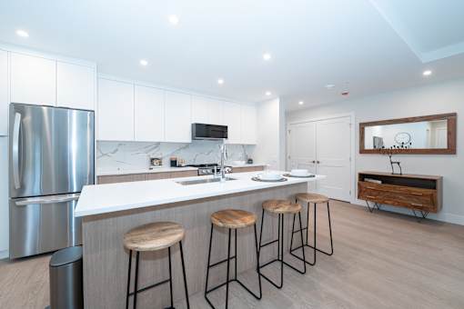 Kitchen with Bar Stools at Woodland Place Apartments, British Columbia