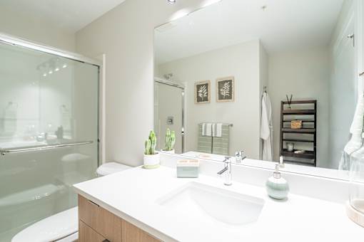 Bathroom with White Interior at Woodland Place Apartments, Langford, BC
