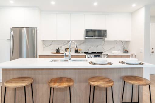 Kitchen with a White Countertop at Woodland Place Apartments, British Columbia