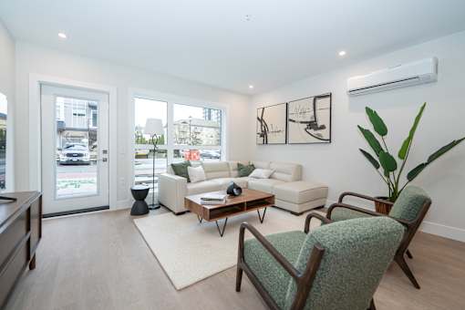Living Room with a Green Chair at Woodland Place Apartments, Langford, L4H 3P6
