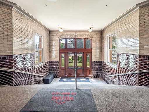 A brick building with a red mat that says "Easton High School" on it.