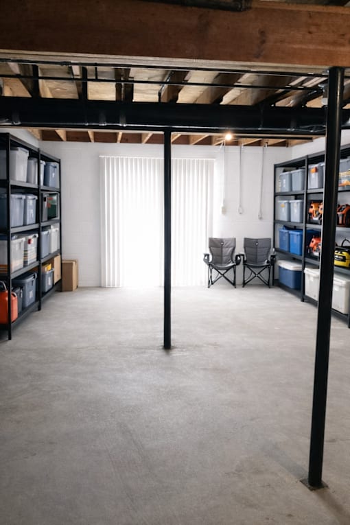 A room with a lot of shelves and a chair.