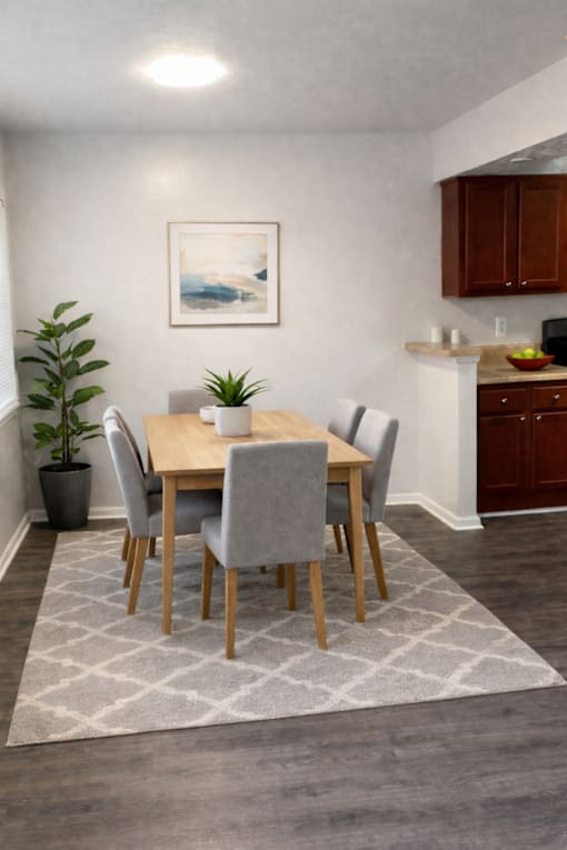 A dining room with a table set for four.
