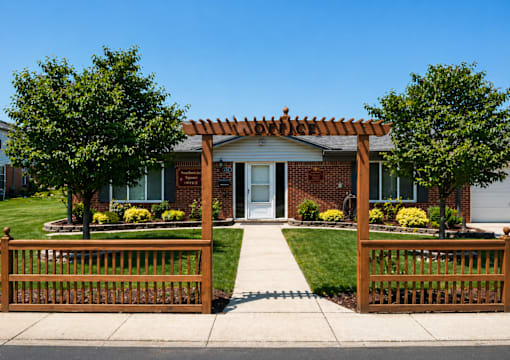 A house with a white door and a brown fence.