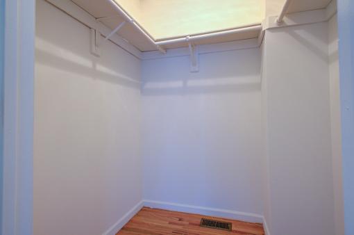 A room with white walls and a wooden floor.