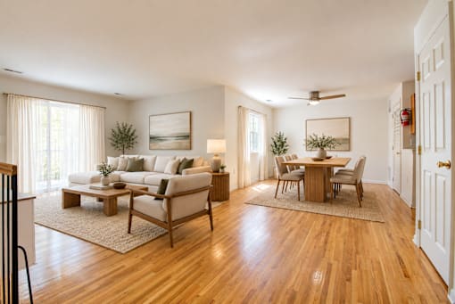 A living room with a couch, coffee table, and chairs.