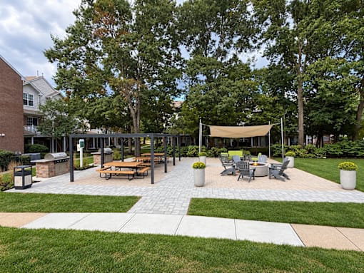 A park area with a picnic table and chairs.