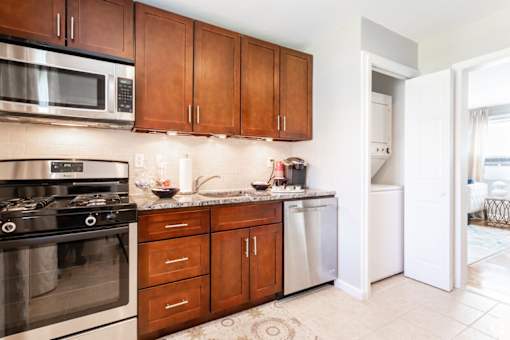 A kitchen with a stove, microwave, and dishwasher.