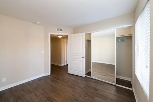 A room with a white door and a white closet.