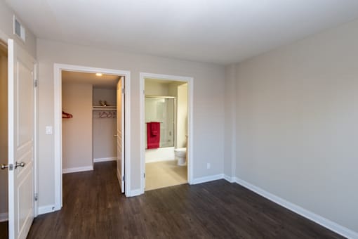 A room with a white wall and a wooden floor.