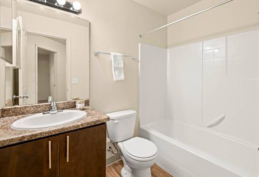 A white toilet sits next to a sink in a bathroom.