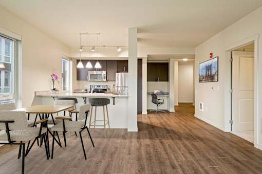A modern kitchen with a dining table and chairs.