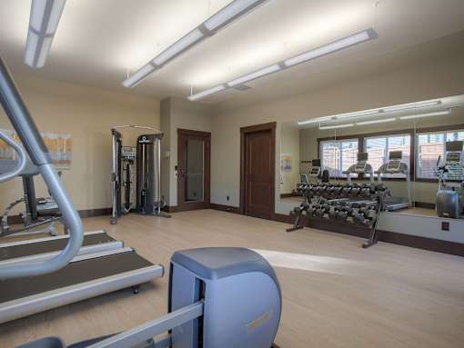 A gym with treadmills, weights, and exercise equipment. at Mill Creek Meadows Apartments, Mill Creek, Washington