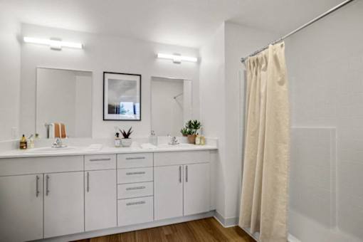 A bathroom with a white cabinet and a shower curtain. at Riverfront Everett, Washington, 98201
