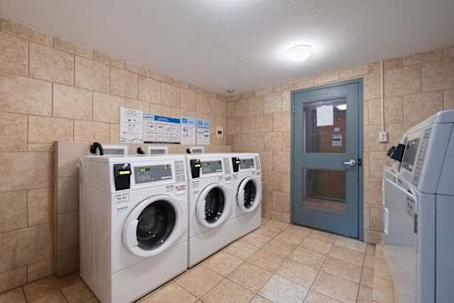 A row of washing machines in a public laundromat.