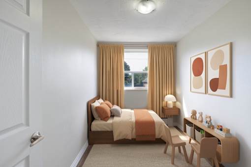 A bedroom with a bed, desk, and chair.
