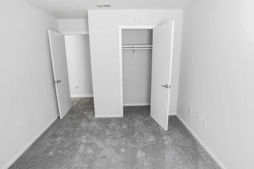 A white room with a doorway leading to another room.