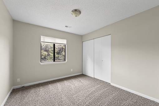 A room with a window and a white door.