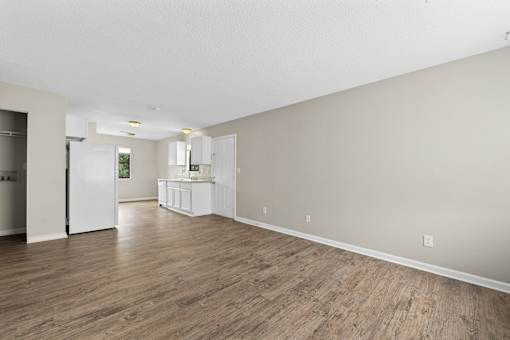 A room with wooden floors and white walls.