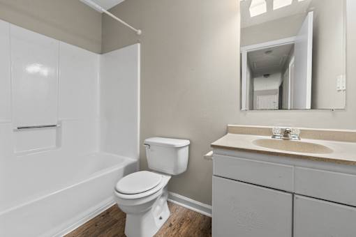 A white toilet sits next to a sink in a bathroom.
