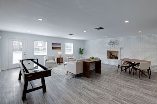 A modern clubhouse with a pool table and a fireplace at Savan Pointe Apartments, Savannah