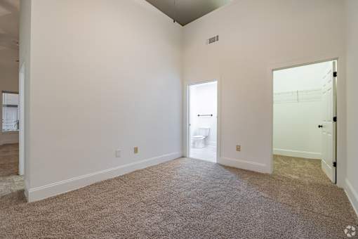 A room with white walls and carpeted floor.
