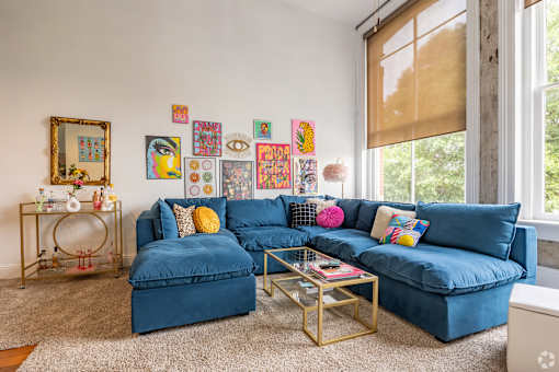 A living room with a blue couch and a coffee table.