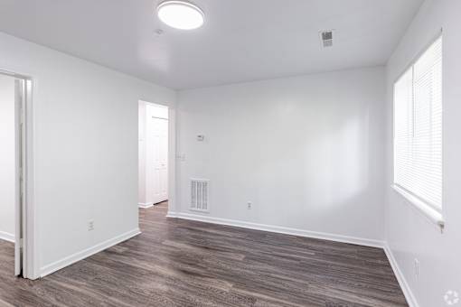 A room with white walls and wood flooring.