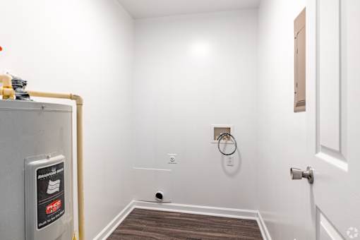 A white wall with a small hole in it.