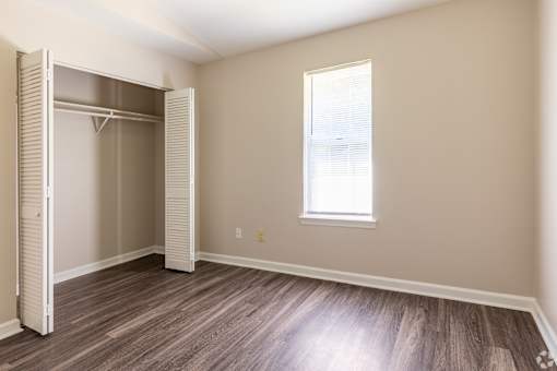 A room with a sliding door and a window.