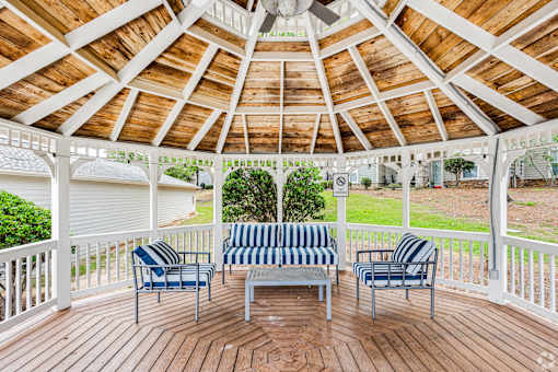 A wooden gazebo that overlooks the pool area