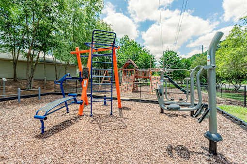 A playground with a swing set and a slide.