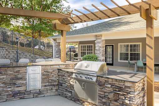 A stone wall with a grill on it.