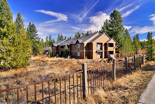 A house with a brown fence in front of it.