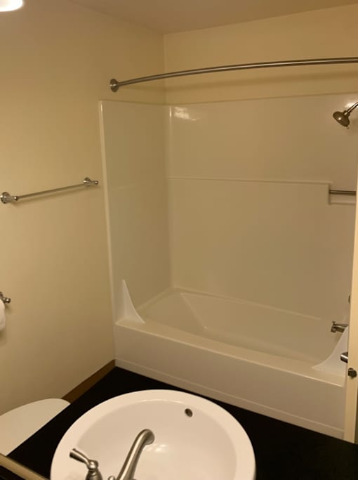 A white sink with a chrome faucet in a small bathroom.
