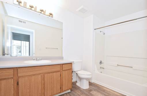A bathroom with a toilet, sink, and bathtub.