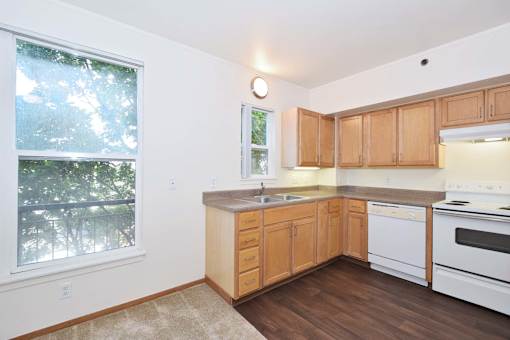 A kitchen with wooden cabinets and white appliances.