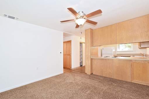 A room with a ceiling fan and a window.