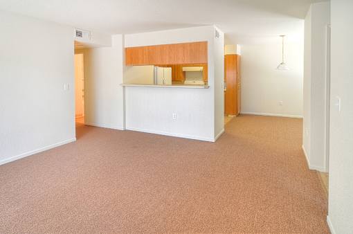 A room with a carpeted floor and white walls.