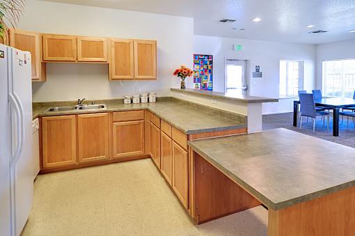 A kitchen with wooden cabinets and a white refrigerator.