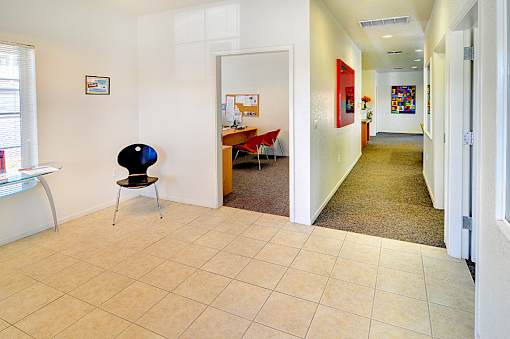 A room with a chair and a table in it.