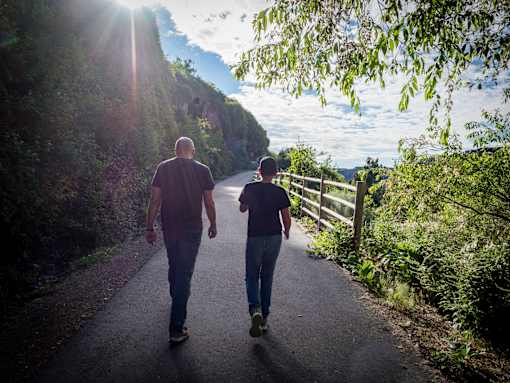 Two people walking down a path.