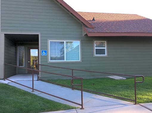 A building with a ramp leading to the entrance.