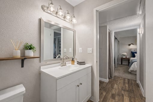 A bathroom with a white sink and a mirror above it. at Infinity on the Landing Apartments , Euless, TX, 76040