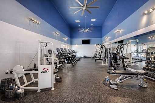 A gym with a variety of equipment including a rowing machine. at Infinity on the Landing Apartments , Euless, Texas