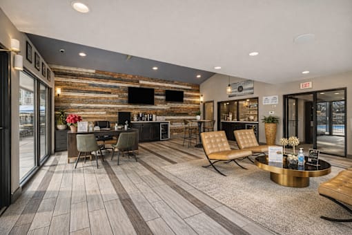 A modern living room with a wooden wall and a grey floor. at Infinity on the Landing Apartments , Texas