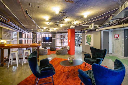 A room with blue chairs and a red carpet.