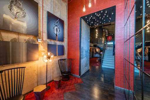A room with a red carpet and a chair.