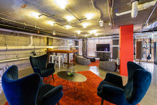 A room with blue chairs and a red carpet.